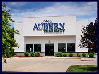 The AuBurn Pharmacy of Eudora, Kansas, is a large white building with a large blue and green AuBurn Pharmacy logo on the front.