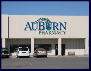 The AuBurn Pharmacy Garnett Location. The pharmacy is connected to Country Mart and has a large blue and green AuBurn Pharmacy Logo